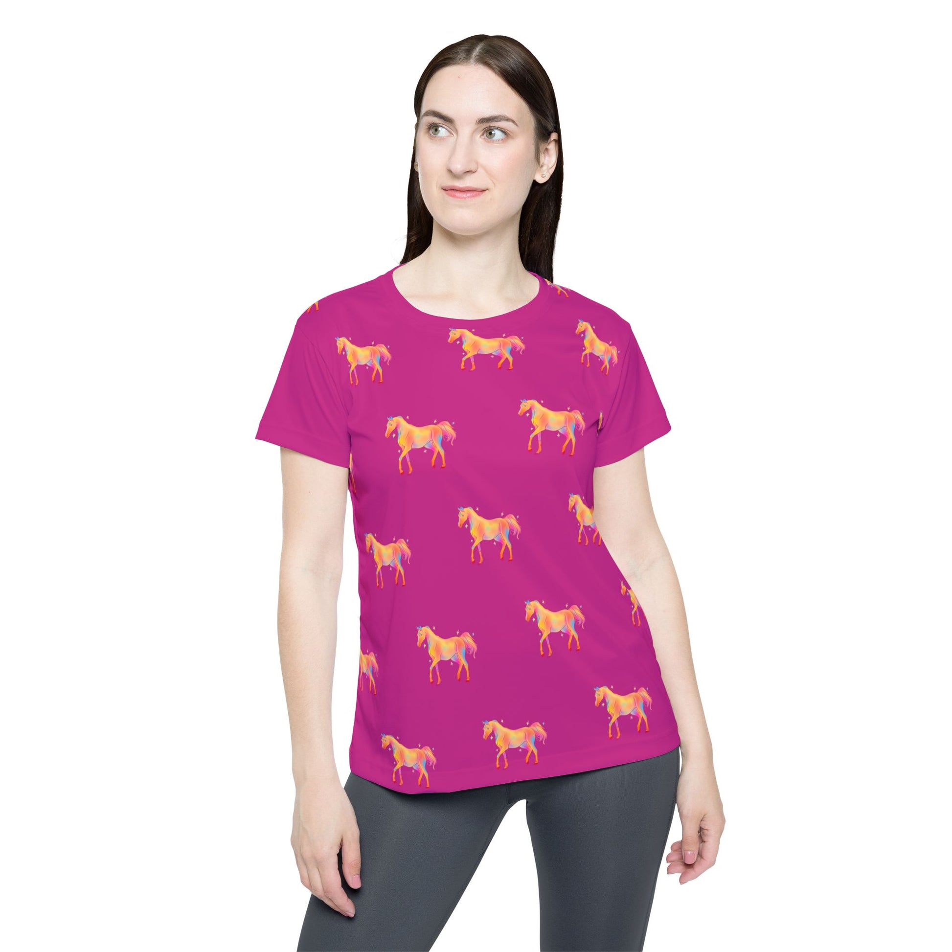 Woman wearing a pink t-shirt with horse patterns on a white background