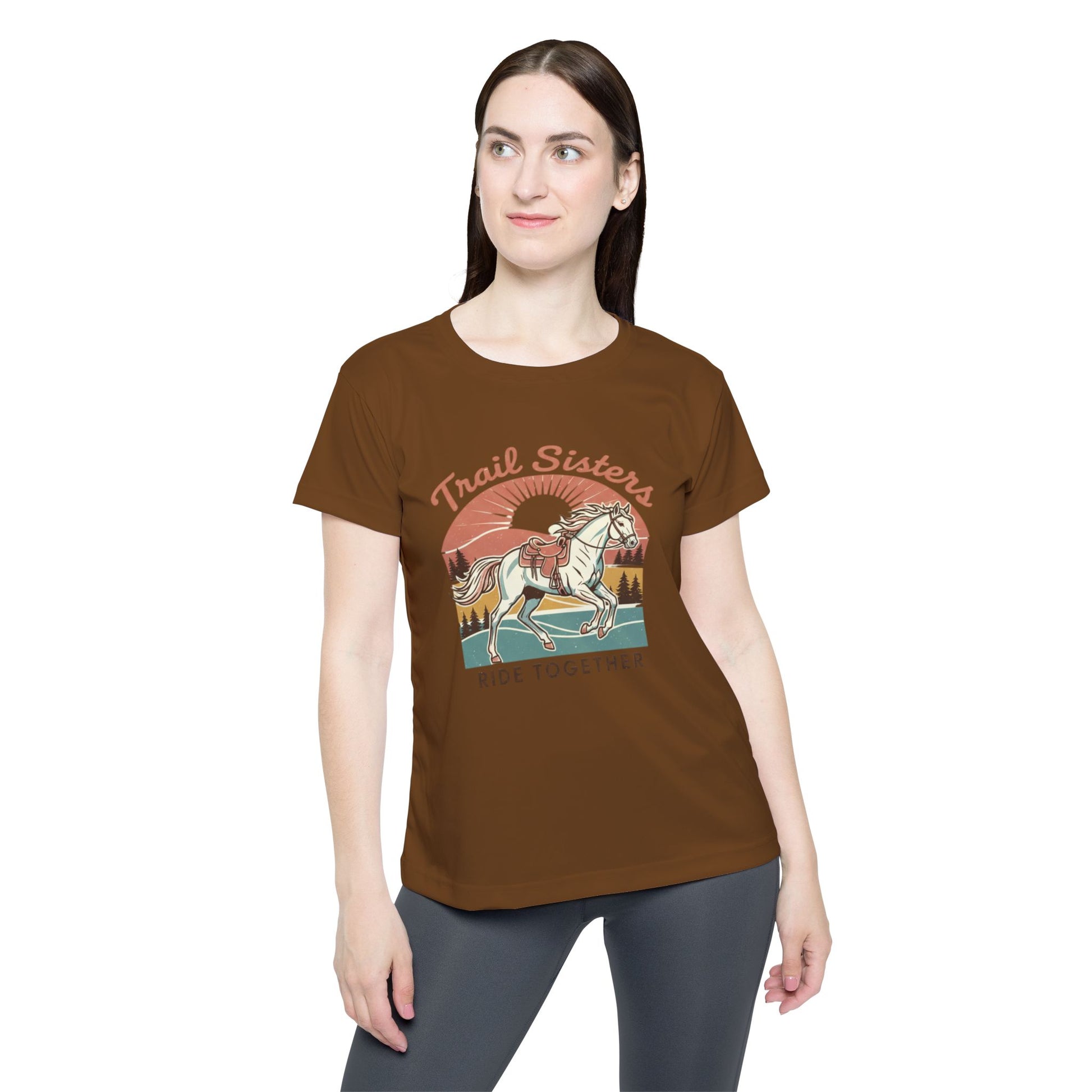Woman wearing a brown t-shirt with a horse graphic and 'Trail Sisters' text on a white background