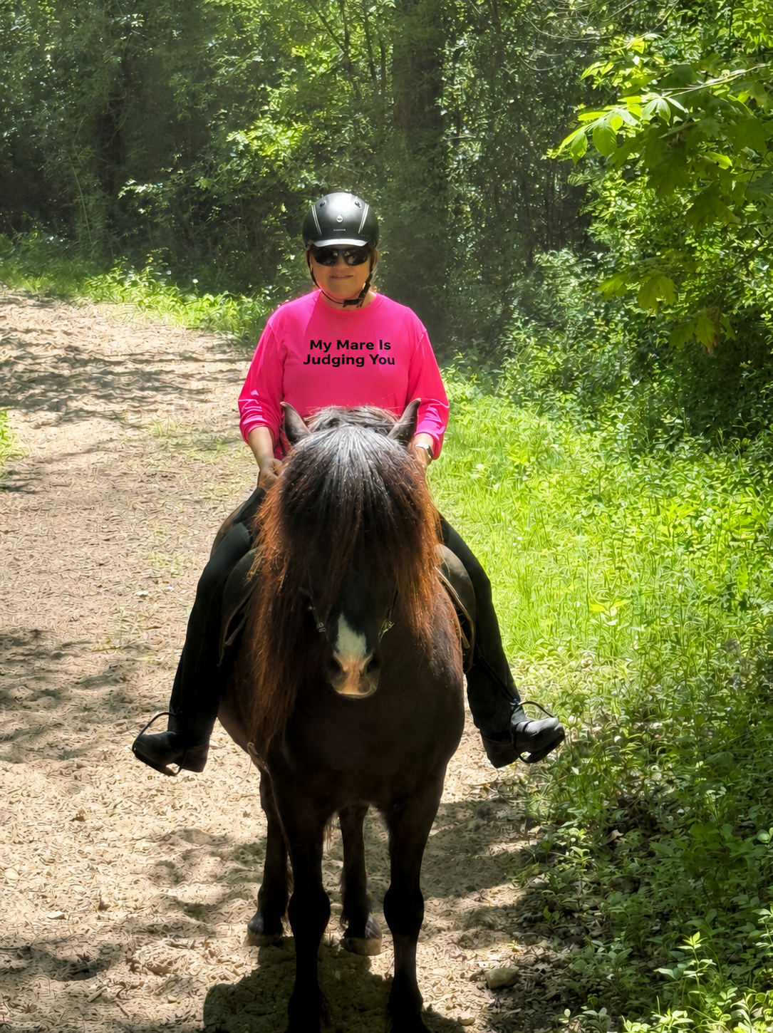 Rider on Icelandic horse wearing My Mare Is Judging You hot pink long sleeve trail shirt
